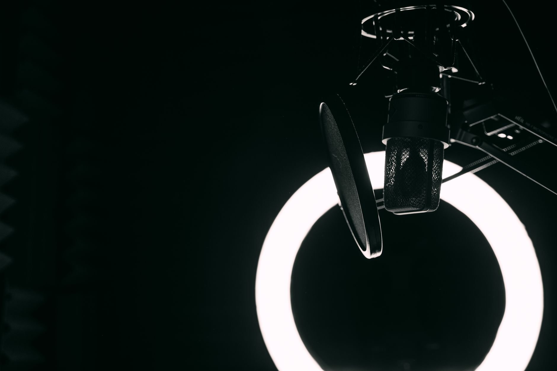 Professional podcast microphone and ring light in a recording studio.